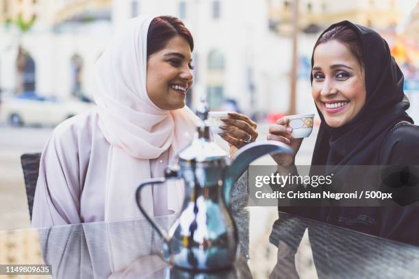 two arabian women spending time together - qatar food stock pictures, royalty-free photos & images