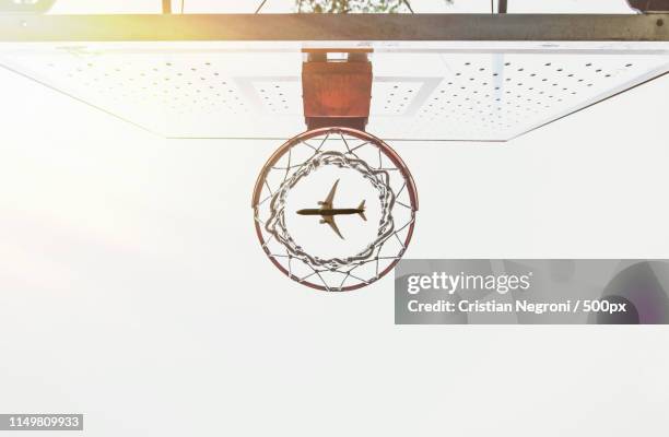 artistic capture with basket and airplane flying in the sky - collegebasket stock pictures, royalty-free photos & images