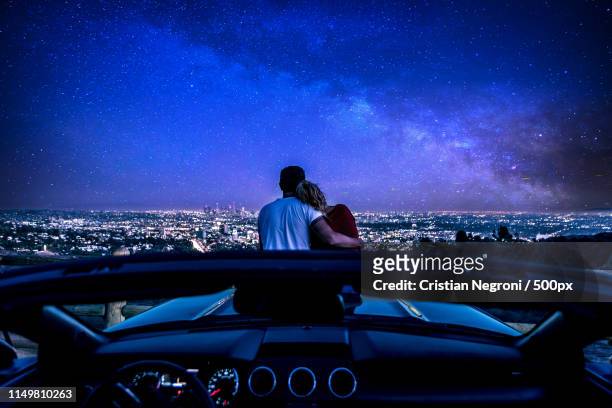 couple watching sunset from popular view point in los angeles, c - driving romance stock pictures, royalty-free photos & images