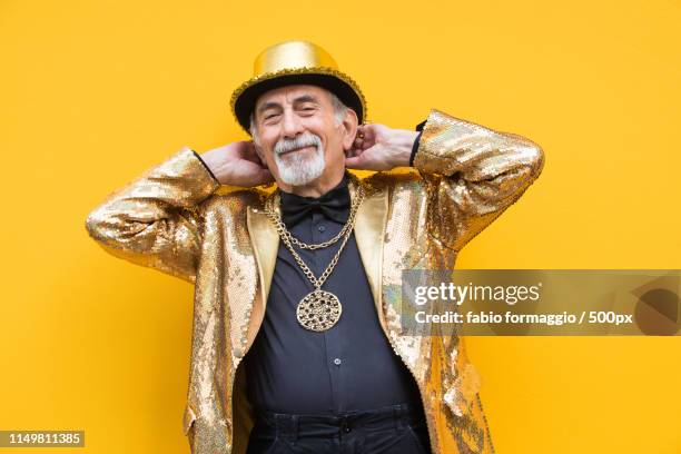 eccentric senior man portrait - gold jacket stock pictures, royalty-free photos & images