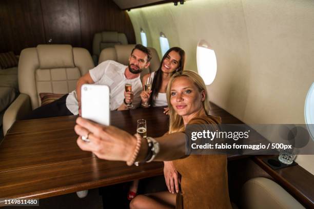 group of friends on private jet - vip room stock pictures, royalty-free photos & images