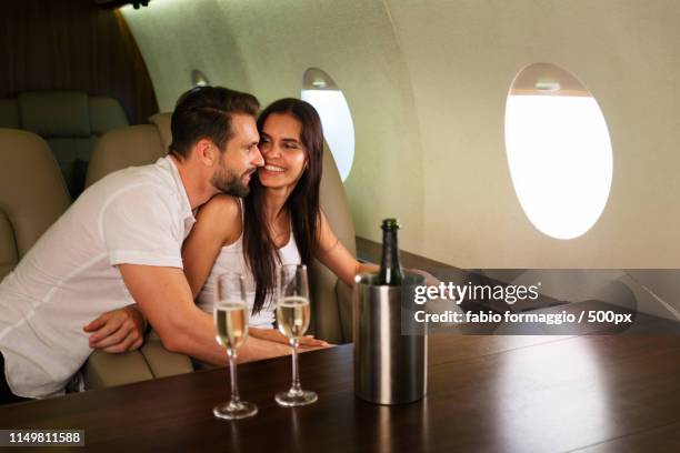 couple on private jet - first class champagne stock pictures, royalty-free photos & images