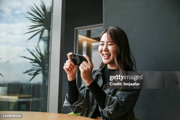 young women playing mobile game and selfie - mobile game stock pictures, royalty-free photos & images