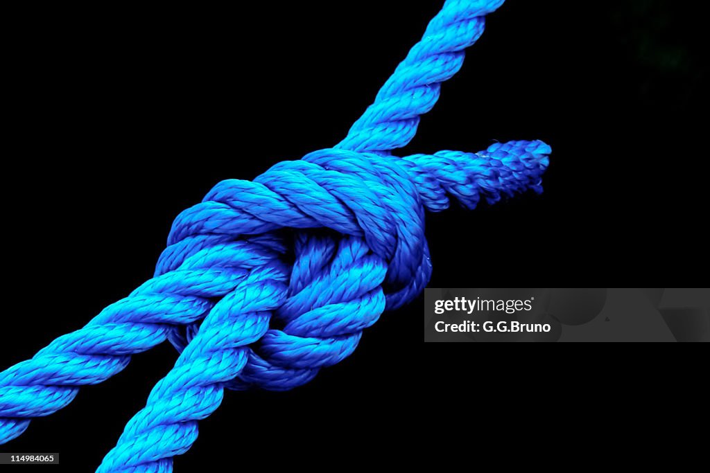 Blue rope knot on black background