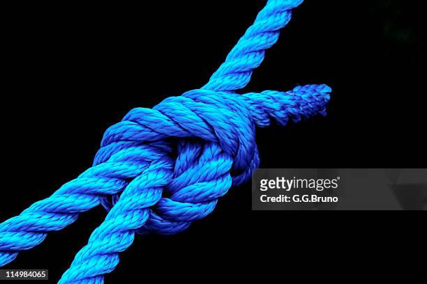 blue rope knot on black background - knots stock pictures, royalty-free photos & images