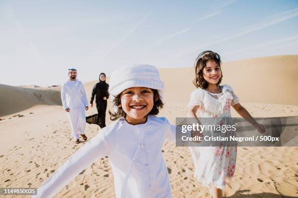 happy family spending a wonderful day in the desert making a pic - arab family happy photos et images de collection