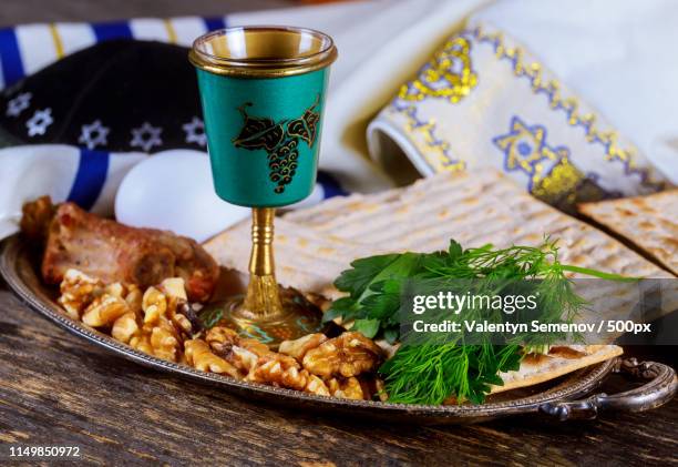 passover jewish day matzoh and kosher wine over wooden table - seder plate stock pictures, royalty-free photos & images