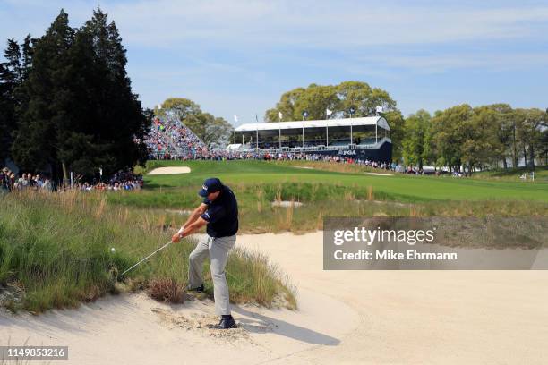 Phil Mickelson of the United States plays a shot from a bunker on the 18th hole during the second round of the 2019 PGA Championship at the Bethpage...