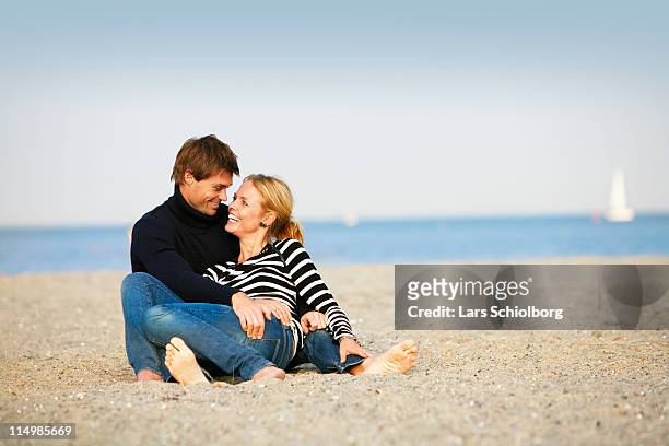young couple on beach - amager stock pictures, royalty-free photos & images