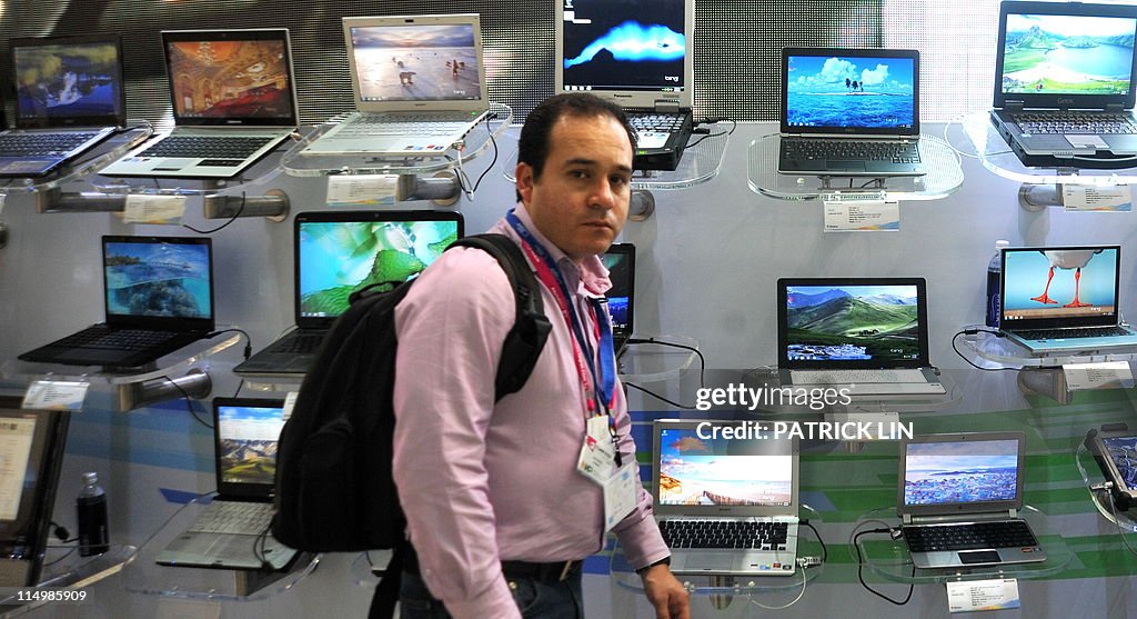 A visitor walks past a Microsoft booth o