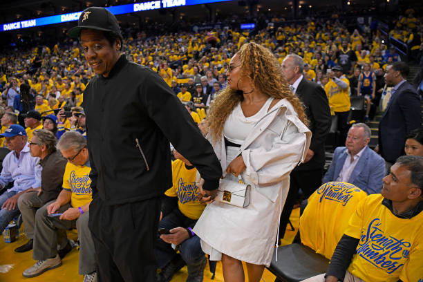 Jay-Z y Beyoncé entran a la cancha durante el tercer cuarto del Juego 1 de las semifinales de la Conferencia Oeste de la NBA en el Oracle Arena en Oakland, California,...