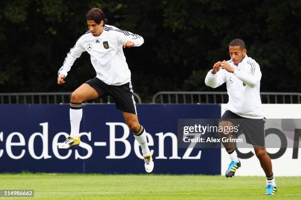 Sami Khedira and Dennis Aogo of Germany exercise during a training session ahead of their UEFA EURO 2012 qualifier against Austria on June 1, 2011 in...