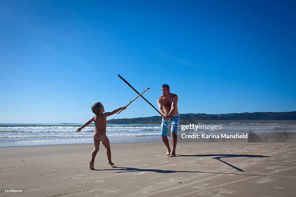 Father and son playing on beach