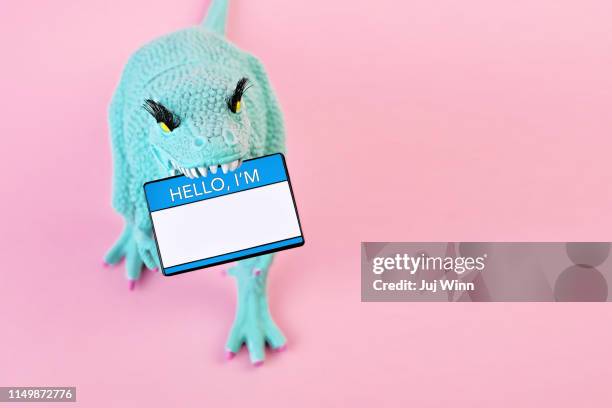toy dinosaur with "hello i'm" nametag - namnskylt bildbanksfoton och bilder