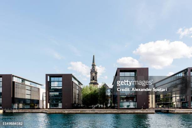 modern building and old church along the canal in copenhagen, denmark - church building stock pictures, royalty-free photos & images