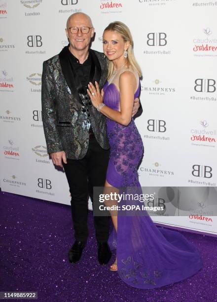 John Caudwell and Modesta Vzesniauskaite arrive for the Caudwell Children Butterfly Ball charity event at the Grosvenor House, Park Lane.