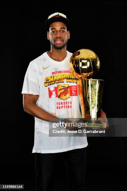 Jordan Loyd of the Toronto Raptors poses for a portrait with the Larry O'Brien Trophy after winning Game Six of the 2019 NBA Finals against the...