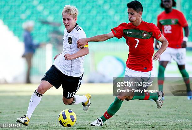 Lewis Holtby of Germany and Andre Almeida of Portugal fight for the ball during the U21 match between Portugal and Germany at Portimao stadium on May...