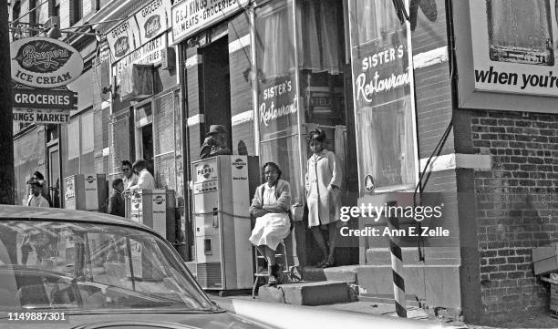 View of people gathered outside various businesses along the route of the 'Walk for Understanding' march through the Central Ward neighborhood on the...