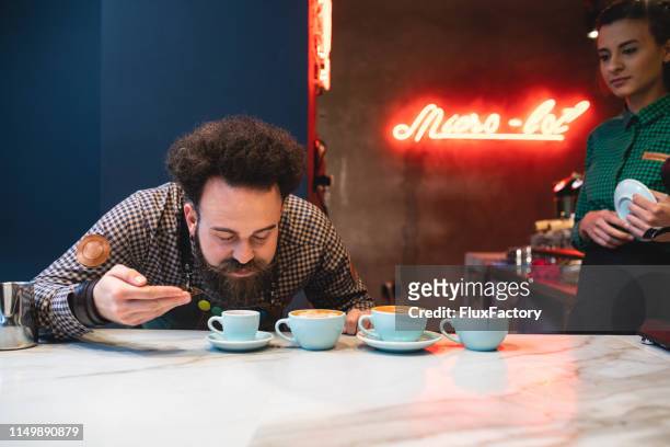 cafe owner smell testing the coffee his workers made - taste test stock pictures, royalty-free photos & images