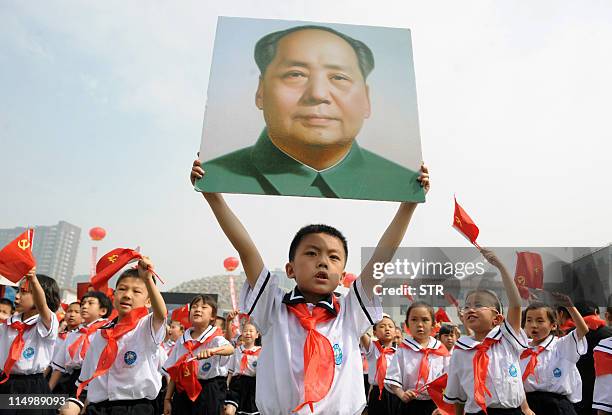 Thousands of Chinese students holding Communist flags and a portrait of China's late leader Mao Zedong gather to mark the 90th anniversary of the...