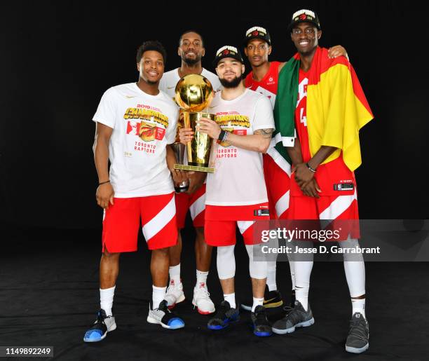 Kyle Lowry Kawhi Leonard Fred VanVleet Malcolm Miller and Pascal Siakam of the Toronto Raptors pose for a portrait with the Larry O'Brien Trophy...