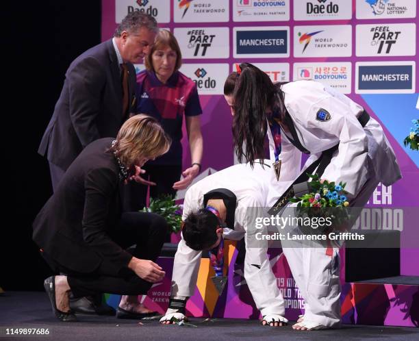 Shuyin Zheng of China collapses during the medal ceremony after defeat by Bianca Walkden of Great Britain in the Final of the Women’s +73kg during...