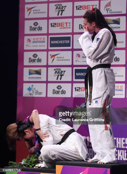 Shuyin Zheng of China collapses during the medal ceremony after defeat by Bianca Walkden of Great Britain in the Final of the Women’s +73kg during...