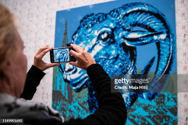 Visitor looks at the "Zodiac" series LEGO portrait series made by Chinese artist and political activist Ai Weiwei during opening of exhibition at the...