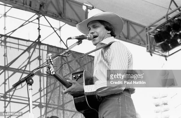 American Country musician George Strait plays guitar as he performs onstage at Chicagofest, Chicago, Illinois, August 30, 1985.