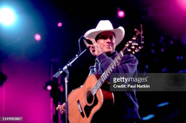 American Country musician George Strait plays guitar as he performs onstage at the Tweeter Center, Tinley Park, Illinois, May 5, 2001.