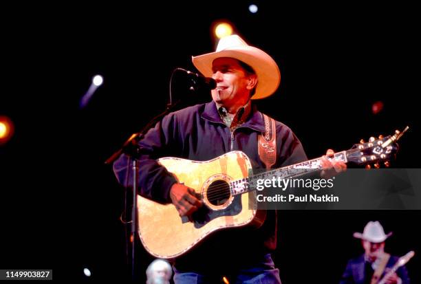 American Country musician George Strait plays guitar as he performs onstage at the Tweeter Center, Tinley Park, Illinois, May 5, 2001.