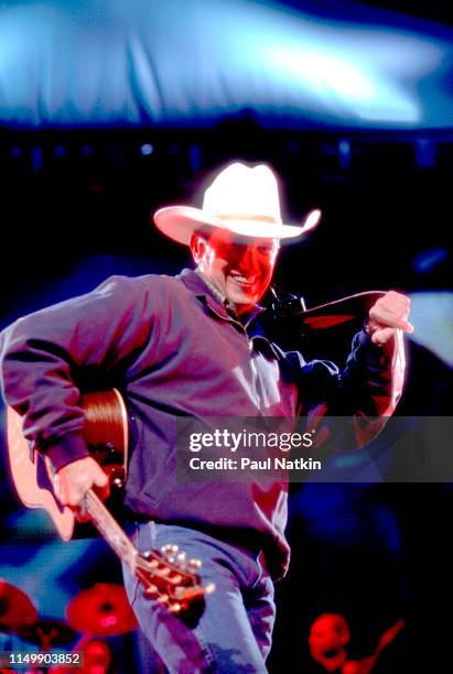 American Country musician George Strait plays guitar as he performs onstage at the Tweeter Center, Tinley Park, Illinois, May 5, 2001.