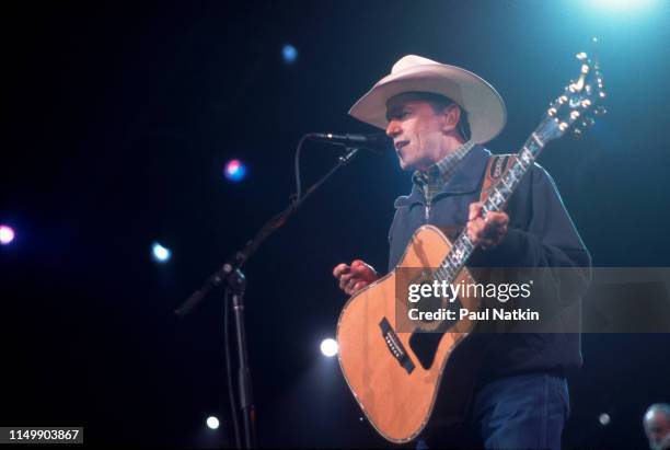 American Country musician George Strait plays guitar as he performs onstage at the Tweeter Center, Tinley Park, Illinois, May 5, 2001.