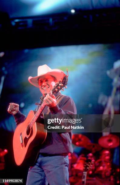 American Country musician George Strait plays guitar as he performs onstage at the Tweeter Center, Tinley Park, Illinois, May 5, 2001.