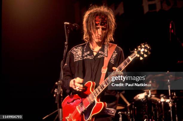 American Rock musician Izzy Stradlin plays guitar as he performs with his band, Izzy Stradlin & The Ju Ju Hounds, onstage at the Metro, Chicago,...