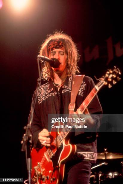 American Rock musician Izzy Stradlin plays guitar as he performs with his band, Izzy Stradlin & The Ju Ju Hounds, onstage at the Metro, Chicago,...