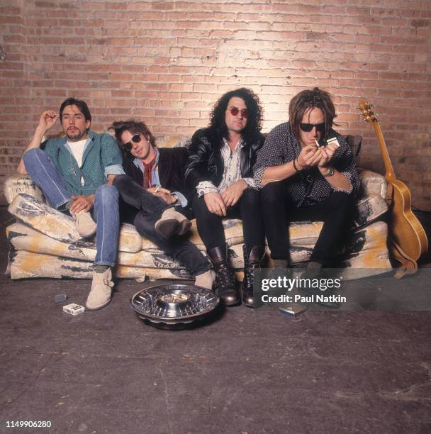 Portrait of American Rock group Izzy Stradlin and the Ju Ju Hounds, seated on a couch, at an unspecified rehearsal space, Chicago, Illinois, May 15,...