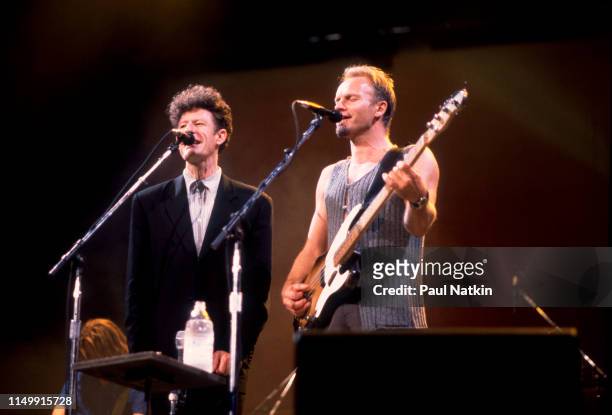 American Country musician Lyle Lovett performs with British musician Sting , on bass guitar, at the Aire Crown Theater, Chicago Illinois, February...