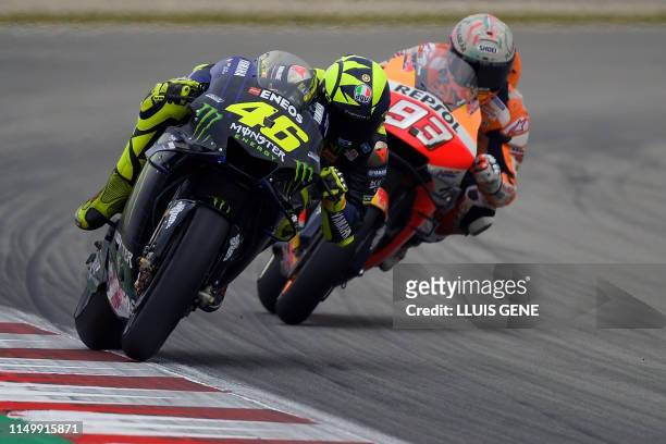 Monster Energy Yamaha's Italian rider Valentino Rossi and Repsol Honda Team's Spanish rider Marc Marquez ride during the Catalunya MotoGP Grand Prix...