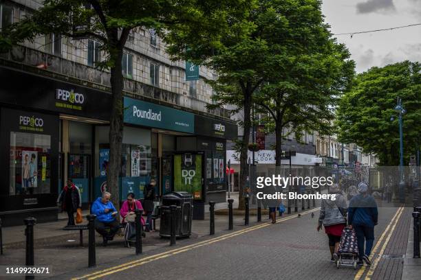 Pedestrians pass a Poundland Group Ltd. Store in the Woolwich district of London, U.K., on Thursday, June 13, 2019. "My frustration is the government...