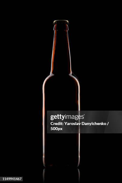 beer bottle isolated on black - flaskkapsyl bildbanksfoton och bilder