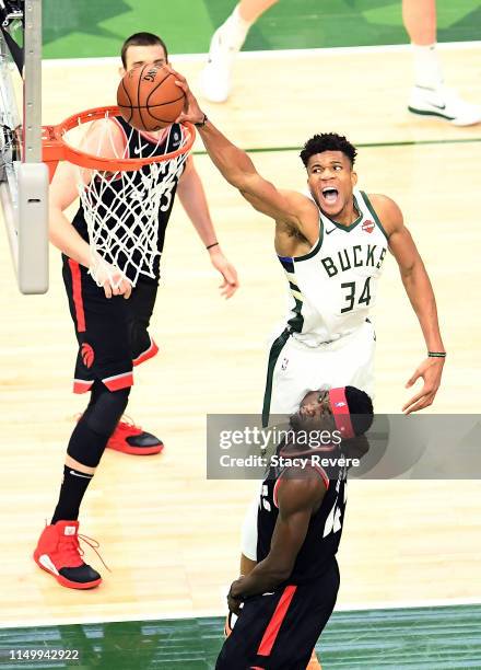 Giannis Antetokounmpo of the Milwaukee Bucks dunks the ball over Pascal Siakam of the Toronto Raptors in the first quarter during Game Two of the...