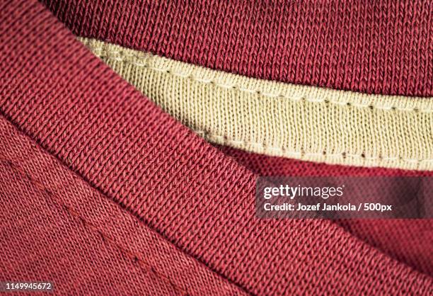 detail of a old pink cotton t-shirt - t shirt texture stock pictures, royalty-free photos & images