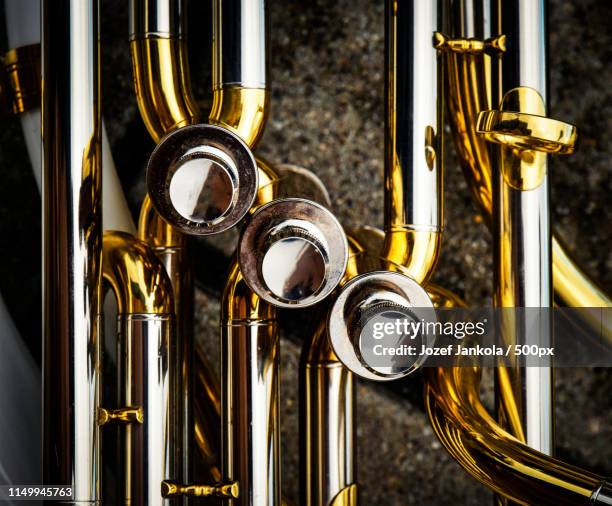 detail on the flaps of the brass sheet music instrument - trombone stock pictures, royalty-free photos & images
