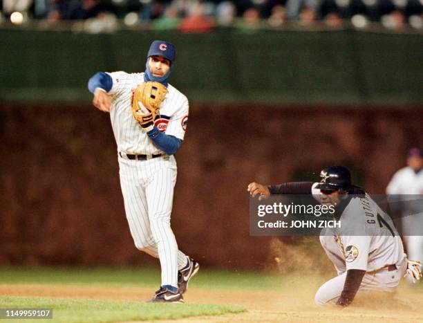 Chicago Cubs shortstop Jose Hernandez turns the double play at second base as the Houston Astros' Ricky Gutierrez watches him make the throw to first...