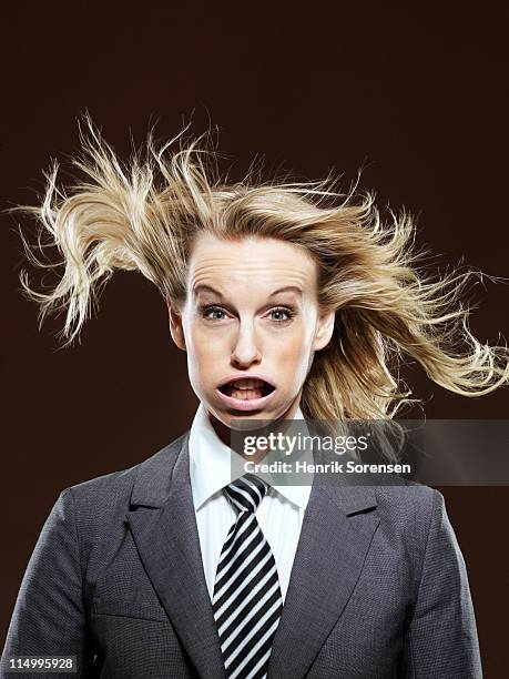 young businesswoman with wind in her face - cheveux au vent photos et images de collection
