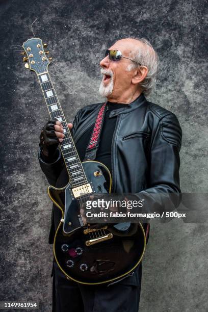 eccentric senior man portrait - heavy metal guitarist stock pictures, royalty-free photos & images