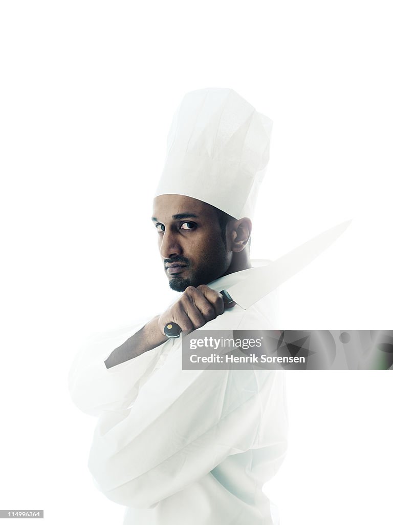 Young male chef with knife