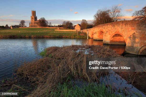 winter sunset, st marys church, river nene, fotheringhay village - northants stock pictures, royalty-free photos & images